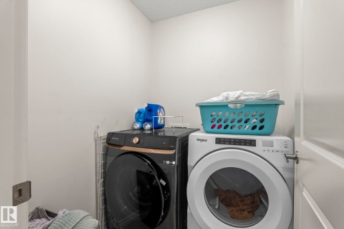 Dedicated laundry area with light-toned walls - 20227 17Ave, Edmonton, AB 