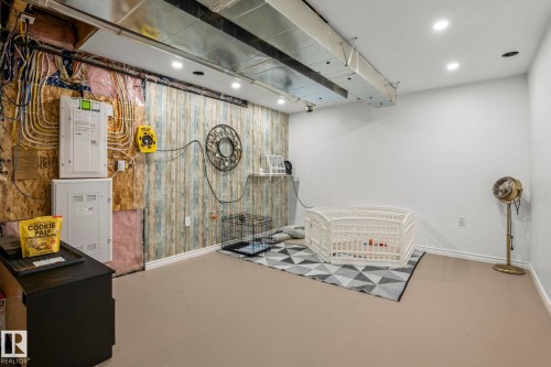 Partially finished basement featuring exposed utilities, a decorative wall, and recessed ceiling lighting - 20227 17Ave, Edmonton, AB 