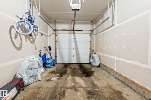 Spacious single-car garage featuring an automatic overhead door - 20227 17Ave, Edmonton, AB 