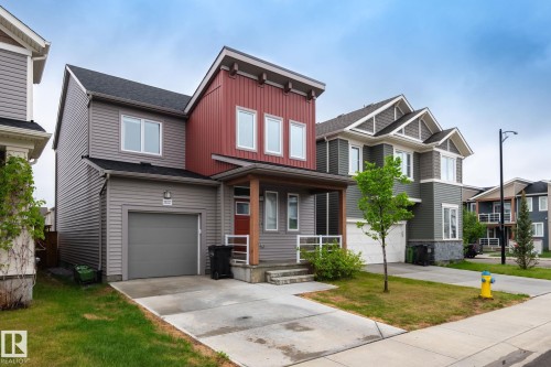 Modern architectural design featuring red vertical siding and gray horizontal siding - 20227 17Ave, Edmonton, AB 