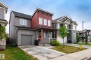 Modern architectural design featuring red vertical siding and gray horizontal siding - 20227 17Ave, Edmonton, AB 