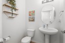 Pedestal sink with chrome faucet, an oval mirror, and chrome vanity lighting - 20227 17Ave, Edmonton, AB 