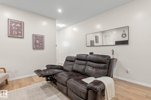 Light wood-finish flooring complements the neutral wall color - 20227 17Ave, Edmonton, AB 