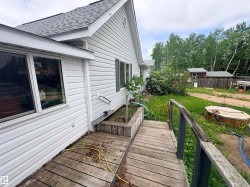 White vinyl siding exterior with an asphalt shingle roof - 