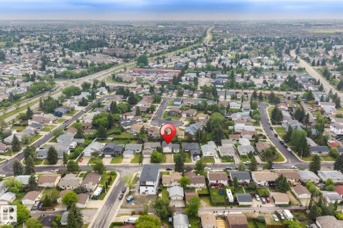 Aerial perspective showcasing a residential neighborhood with numerous single-family homes and mature trees - 2045 46St, Edmonton, AB 