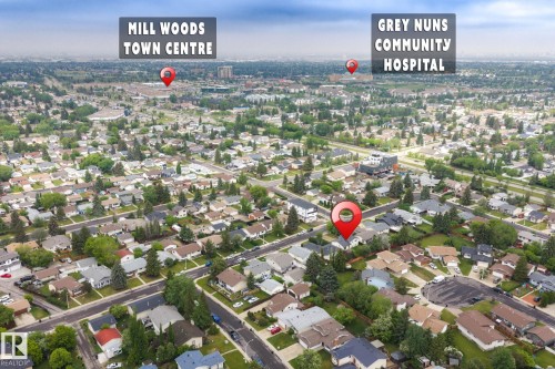 Aerial perspective of a residential neighborhood featuring numerous single-family homes with pitched roofs and mature tree-lined streets - 2045 46St, Edmonton, AB 
