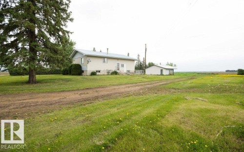 Rural property featuring a two-story home with light-colored siding and a metal roof - 2021 Twp Rd 604, Rural Westlock County, AB 