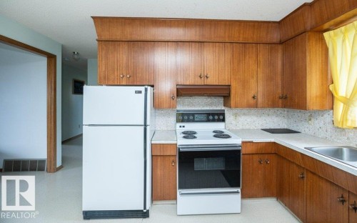 Kitchen featuring wood-finish cabinetry and white appliances - 2021 Twp Rd 604, Rural Westlock County, AB 