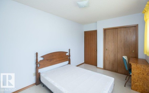 Bedroom featuring light-toned walls, a textured ceiling, and neutral carpet flooring - 2021 Twp Rd 604, Rural Westlock County, AB 