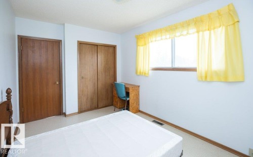 Room featuring light-colored walls, wood-finish interior door, and a two-panel sliding closet - 2021 Twp Rd 604, Rural Westlock County, AB 