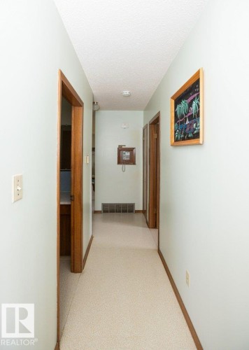 Hallway featuring light-colored walls, wood-finish door frames, and carpeted flooring - 2021 Twp Rd 604, Rural Westlock County, AB 