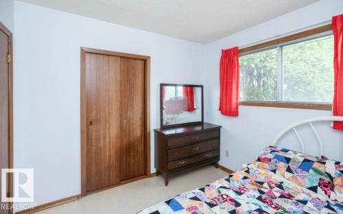 Bright interior space featuring a window with exterior views, light-colored walls, and wood-finish sliding closet doors - 2021 Twp Rd 604, Rural Westlock County, AB 