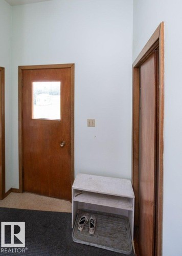 Entryway featuring a wood-panel door with a window, wood trim, and light-colored walls - 2021 Twp Rd 604, Rural Westlock County, AB 