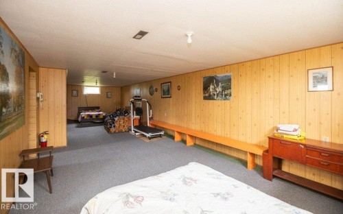 Expansive lower level featuring wood-panel walls and carpeted flooring - 2021 Twp Rd 604, Rural Westlock County, AB 