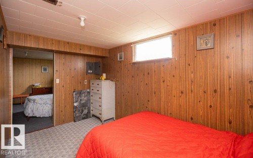 Wood-paneled room featuring patterned carpet flooring, a drop ceiling with recessed lighting, and a horizontal window - 2021 Twp Rd 604, Rural Westlock County, AB 