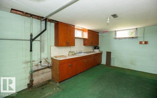 Lower-level utility area featuring painted block walls and a drop ceiling - 2021 Twp Rd 604, Rural Westlock County, AB 