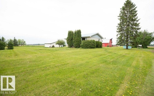 Expansive green lawn with established trees and shrubs - 2021 Twp Rd 604, Rural Westlock County, AB 