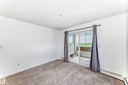 Sliding glass door leading to an outdoor patio area - 126 10535 122 Street, Edmonton, AB 