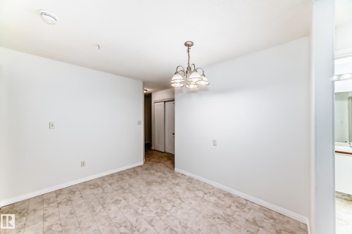 Neutral tone flooring complements white walls - 126 10535 122 Street, Edmonton, AB 