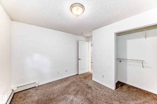Neutral wall tones enhance this room with textured carpeting - 126 10535 122 Street, Edmonton, AB 