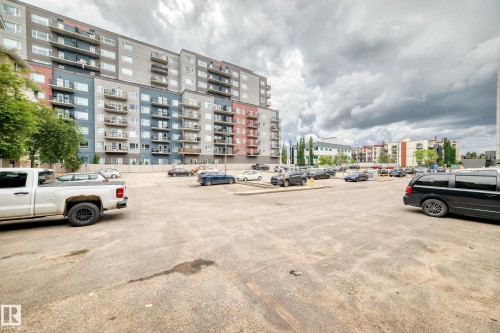 Paved surface parking area with surrounding multi-story residential buildings - 126 10535 122 Street, Edmonton, AB 