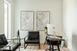 Light wood-finish flooring complements the neutral wall color - 