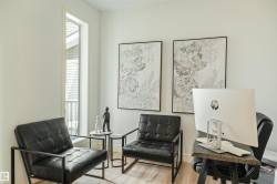 Bright interior space featuring a tall, slender window, wood-finish flooring, and light-toned walls - 