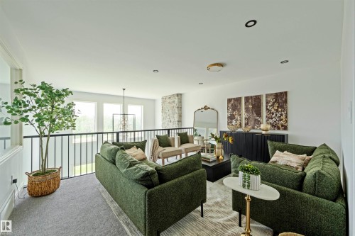 Spacious open loft area featuring a wrought iron railing, expansive windows, recessed lighting, and a modern chandelier - 3329 Chickadee Drive, Edmonton, AB 