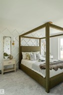 Wall-mounted sconces illuminate a textured accent wall - 
