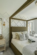 Textured wall paneling with a diamond pattern, accented by brass wall sconces - 