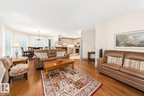 Open-concept living area featuring wood-finish flooring - 512 3 Perron Street, St. Albert, AB 