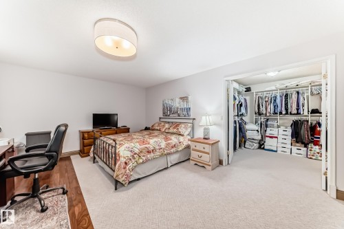 Bedroom featuring a neutral wall color, recessed lighting, and a combination of carpet and wood-finish flooring - 512 3 Perron Street, St. Albert, AB 