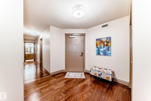 Entryway featuring rich wood-finish flooring, a solid core entry door, and recessed lighting - 512 3 Perron Street, St. Albert, AB 