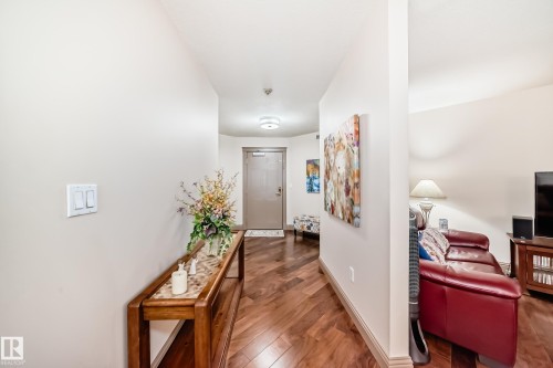 Entryway featuring wood-finish flooring, light neutral wall tones, and a flush-mount ceiling light - 512 3 Perron Street, St. Albert, AB 