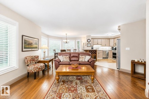 Open-concept living space featuring wood-finish flooring, recessed lighting, and a bay window dining area - 512 3 Perron Street, St. Albert, AB 