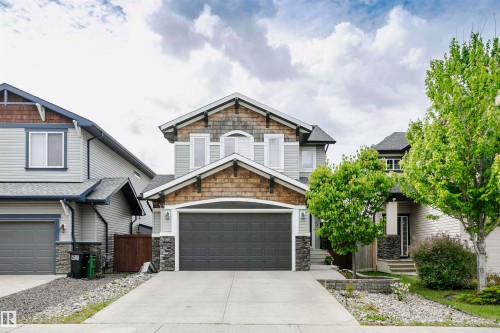 Contemporary two-story residence with light gray siding and wood-shingle accents - 21807 97 Avenue, Edmonton, AB 