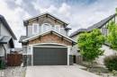 Two-story residence featuring light gray siding and natural wood shingle accents - 21807 97 Avenue, Edmonton, AB 