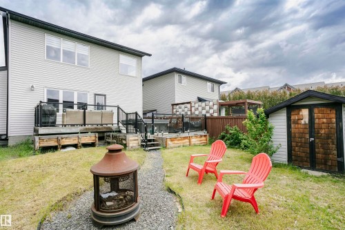 Expansive backyard with a manicured lawn, gravel pathway, and a detached storage shed - 21807 97 Avenue, Edmonton, AB 