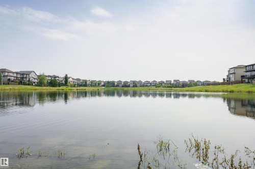 Waterfront properties featuring diverse architectural styles and mature landscaping - 21807 97 Avenue, Edmonton, AB 