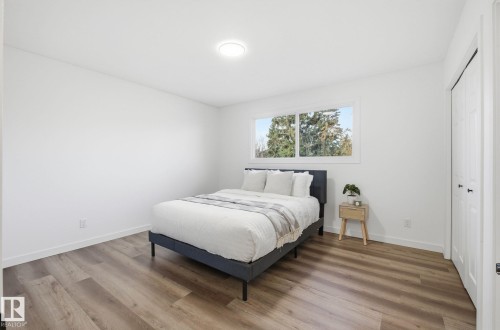 Bedroom with light wood-type flooring and two closets - 2722 104A Street, Edmonton, AB 