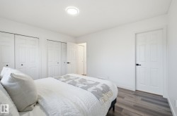 Bedroom with multiple closets and wood finished floors - 