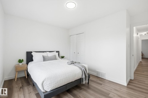 Third large bedroom upstairs, featuring wood finished floors and a closet - 2722 104A Street, Edmonton, AB 