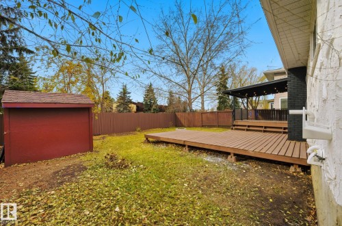 Fenced backyard with a deck and a storage shed - 2722 104A Street, Edmonton, AB 