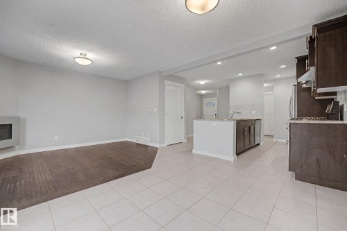 Open-concept living space featuring light gray walls and recessed lighting - 16810 53 Street, Edmonton, AB 