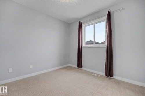 Neutral-toned carpeting paired with light gray wall paint - 16810 53 Street, Edmonton, AB 