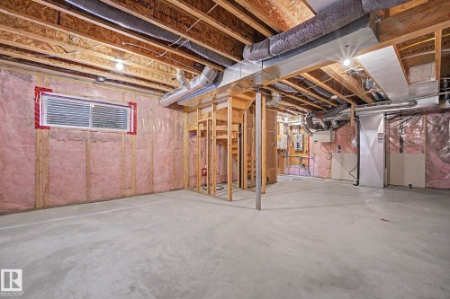 Spacious unfinished basement with concrete flooring and exposed wooden joists - 16810 53 Street, Edmonton, AB 