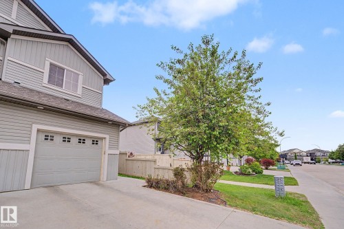 Two-story exterior with light gray horizontal siding and white trim - 16810 53 Street, Edmonton, AB 