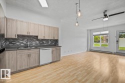 Open-concept living area featuring light wood-finish flooring throughout - 