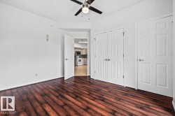 Rich wood-finish flooring complements crisp white walls - 