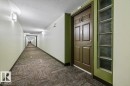 Entry door with decorative paneling and a frosted glass block sidelight - 116 6315 135 Avenue, Edmonton, AB 